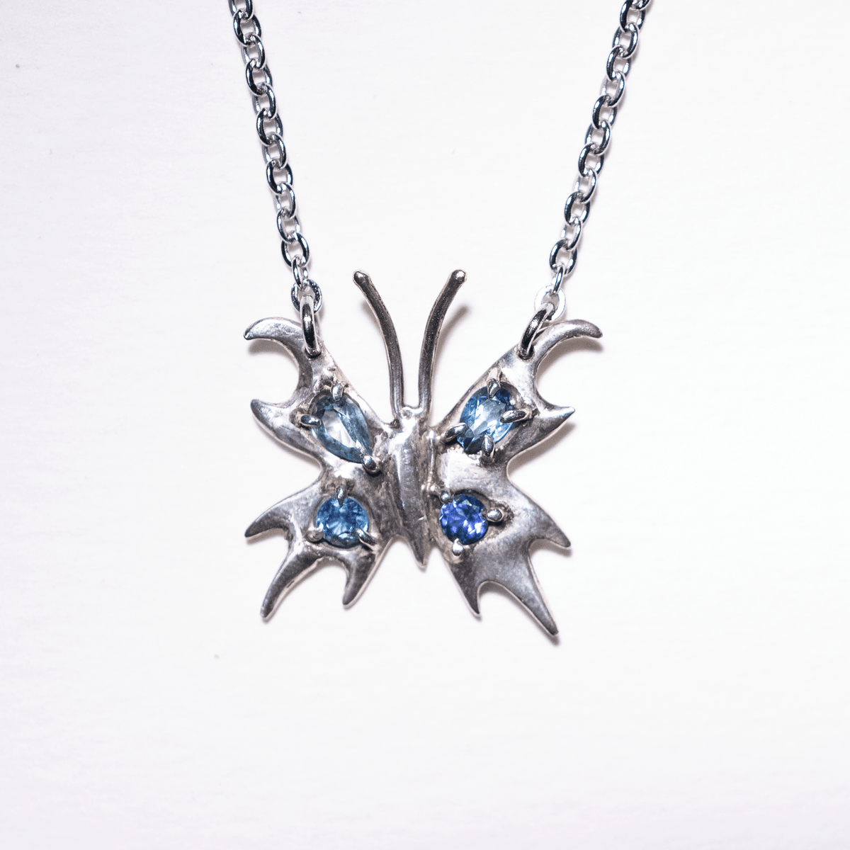 Chrome Pappillion Necklace with Blue Stones