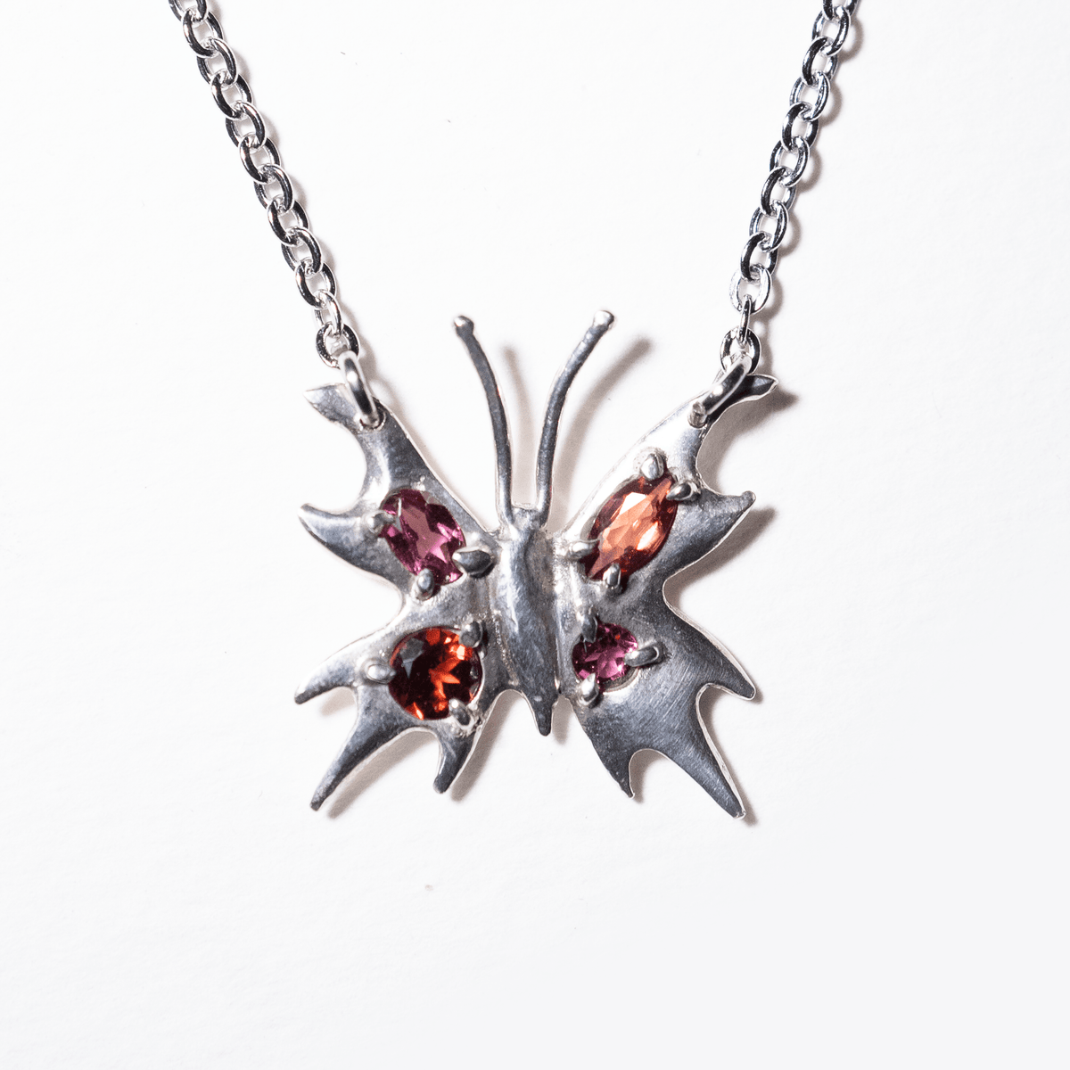 Chrome Pappillion Necklace with Red Stones
