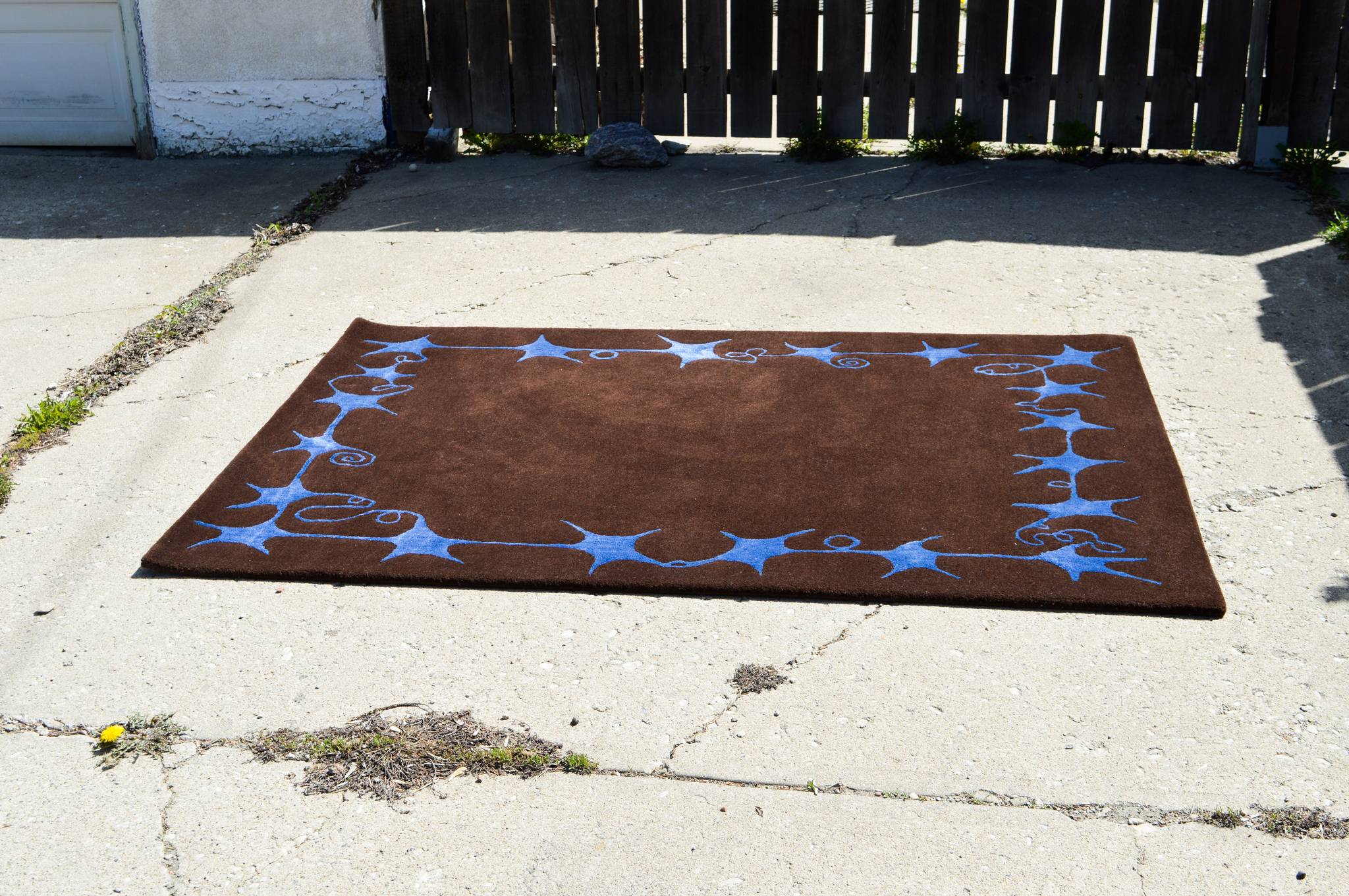The Swirly Star Rug in Brown